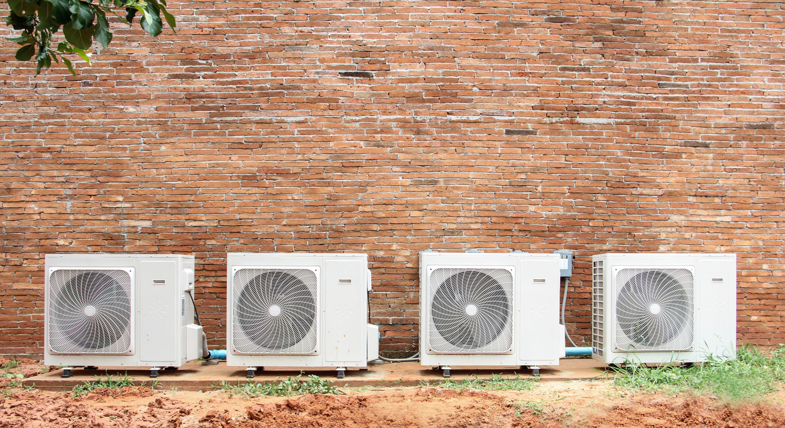 air conditioning compressor on brick wall.