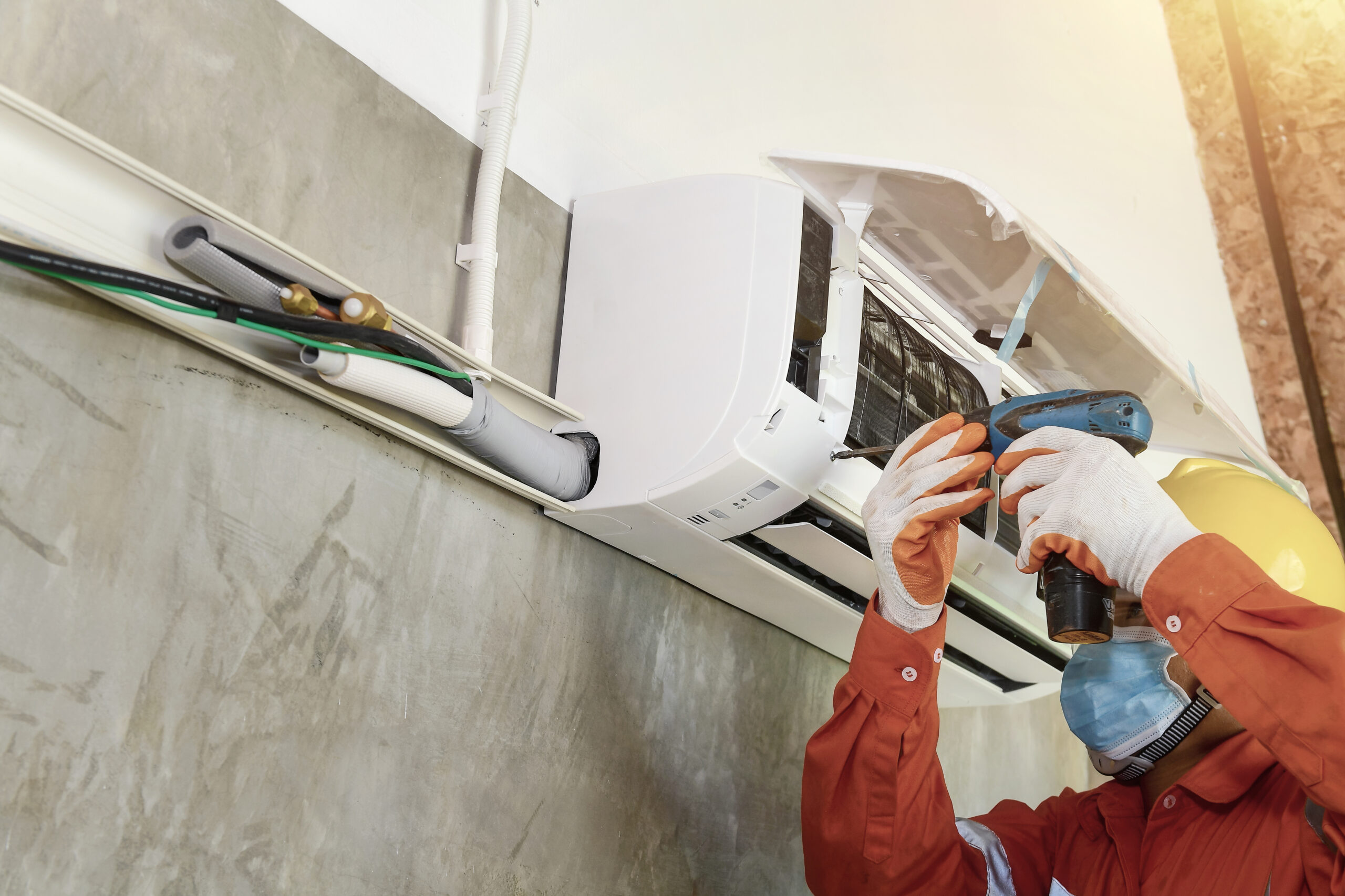 a young asian air conditioner technician or air conditioning ins